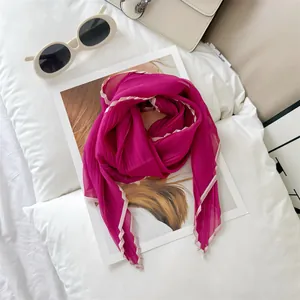 Detailed macro view of magenta pleated edge lightweight scarf on a white lifestyle background
