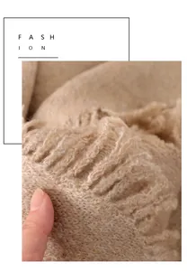 Vista macro detallada de la suave textura de punto beige de bufanda de invierno con flecos