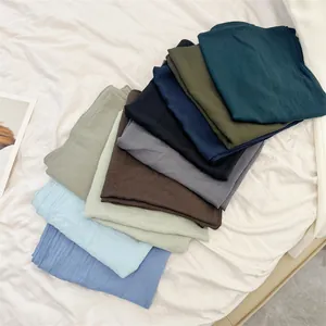 Detailed view of assorted soft crinkle cotton feel square scarves in multiple colors
