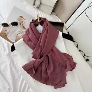 Detailed view of a burgundy wrinkled cotton blend scarf with a premium fashion vibe.
