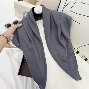 Detail of charcoal grey pleated square scarf with soft cotton feel texture