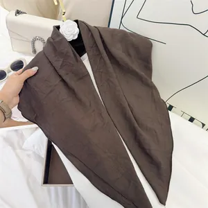 Detail of soft breathable brown wrinkled cotton-feel square scarf with fine texture
