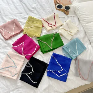 Lightweight pleated scarves with contrast zigzag edges in various vibrant solid colors