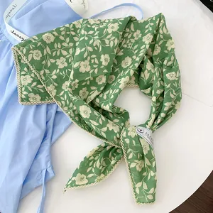 Detail of green floral print 100% cotton square scarf with delicate lace trim