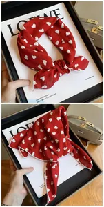 Detailed view of red cotton square scarf with white heart pattern for hair and neck