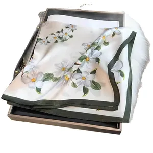 Elegant white floral square silk scarf with a green border and delicate flower pattern