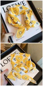 Detailed view of a yellow floral cotton square scarf, perfect for hair or neck styling.