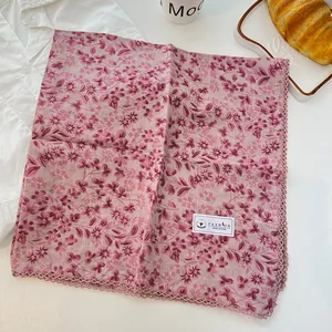 Detail view of pink floral 100% cotton square scarf with crochet lace edges
