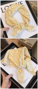 Close-up detail of yellow cotton floral print scarf used as hairband or neckerchief
