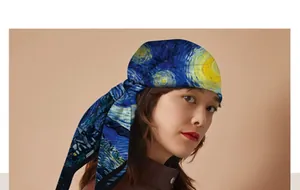 Van Gogh Starry Night print silk scarf worn as a stylish head wrap by an Asian model.