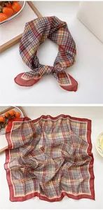 Detailed view of red plaid square scarf with vibrant grid pattern and elegant red border