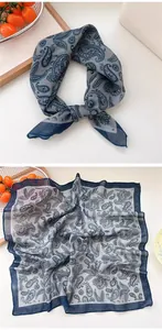 Detailed view of an elegant grey and navy blue paisley print square silk scarf bandana