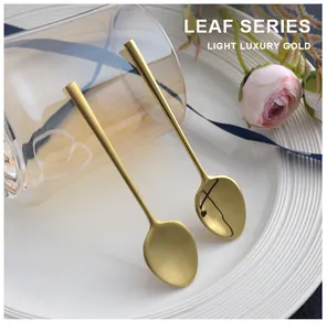Detailed view of two elegant gold stainless steel coffee spoons with matte and glossy finishes