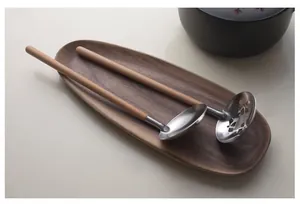 Close-up of 304 stainless steel soup ladle and slotted spoon with wooden handles