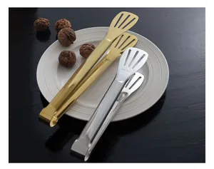 Detail view of gold and silver SUS 304 stainless steel flat-head food tongs on a plate