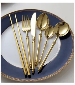 Luxury golden 304 stainless steel cutlery set with bamboo node handle design on a plate