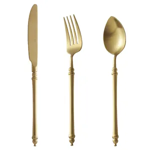 Elegant matte gold 304 stainless steel cutlery set featuring knife fork and spoon on white background