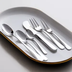 Elegant HOHER stainless steel cutlery set displayed on a white gold-rimmed ceramic plate