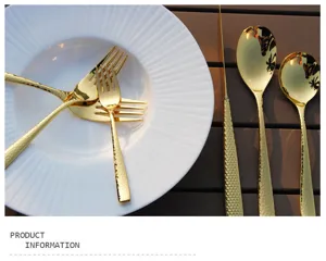 Detail of gold-plated stainless steel cutlery with hammered texture on a white plate