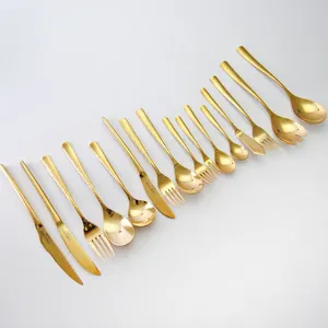 Complete set of golden hammered stainless steel cutlery including steak knives forks and spoons