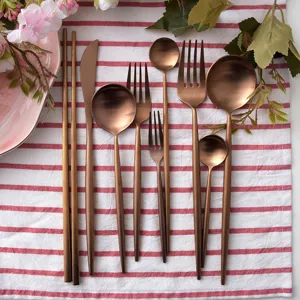 Elegant matte rose gold stainless steel cutlery set with Portuguese style round handles.