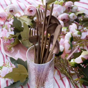 Matte rose gold cutlery set with round handles for steak, fruit, and coffee beverages.