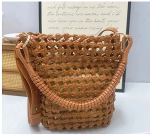 Detailed view of the intricate handmade woven PU leather handbag in rich brown