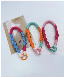 Close-up view of three handmade woven multipurpose phone lanyards with metal ring clasps
