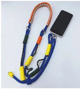 Handmade multi-color woven paracord phone strap shown connected to a smartphone on white background