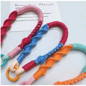Close-up of colorful handmade braided straps with matching rings for phones or keys