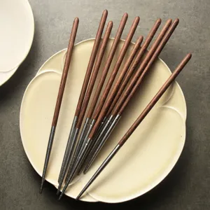 Eco-friendly 304 stainless steel and wenge wood chopsticks set on a beige ceramic plate