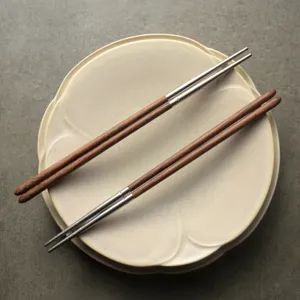 Premium 304 stainless steel and wenge wood chopsticks displayed on a ceramic plate