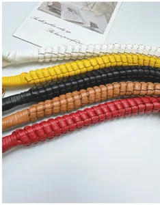 Close-up of vibrant handmade woven PU leather bag straps showing intricate texture details.