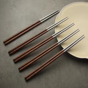 Premium five-pair wenge wood and 304 stainless steel chopsticks set on minimalist plate.