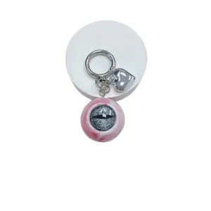 Gothic horror eyeball keychain featuring marbled pink eye pendant and polished silver heart charm
