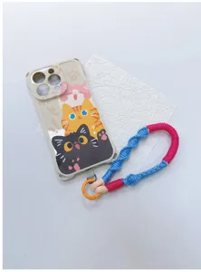 Detailed view of a handmade braided phone lanyard paired with a cartoon cat phone case