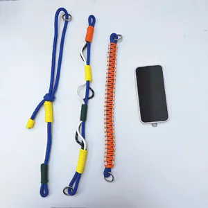 Handmade woven phone lanyards in vibrant blue and orange with scale reference phone