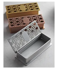Detailed macro view of hollow-out stainless steel palace style toothpick boxes in 3 colors.