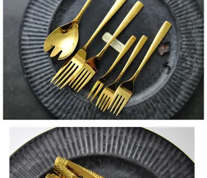 Close-up of hammered gold 304 stainless steel cutlery set with mirror finish on black plate.