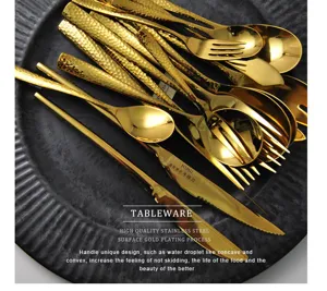 Detail showing golden hammer-textured handles of the stainless steel cutlery set