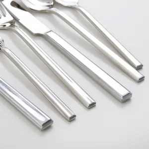 Minimalist stainless steel cutlery set with square-ended handles for elegant dining.