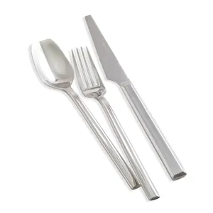 Modern stainless steel cutlery set including steak knife, fork, and spoon for dining