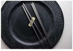Detail showing the matte finish and square head design of vintage stainless steel chopsticks