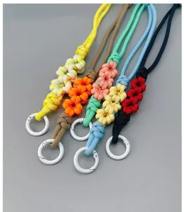 Detailed view of colorful braided daisy wrist straps with white metal clasps