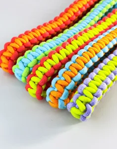 Detailed macro view of vibrant hand-braided colorful cords with intricate textures