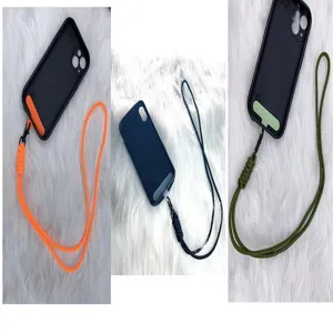 Detailed view of woven phone lanyards in three colors with cases on white fur background