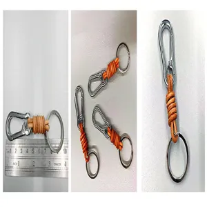 Close-up of a vintage leather carabiner keychain with a ruler showing length measurement.