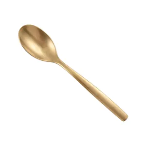 Elegant matte gold stainless steel dinner spoon on white background