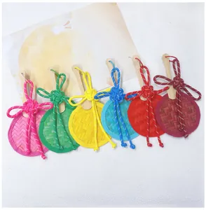 Close-up of colorful handmade bamboo woven fan pendants with traditional knots.
