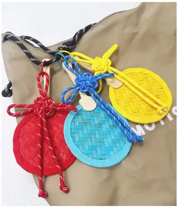 Close-up of handmade bamboo woven fan pendants with decorative Chinese knots in vibrant colors